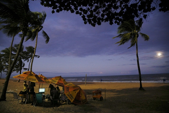 People watch the opening match of the 2014 World Cup between Brazil and Croatia on the beach in Recife