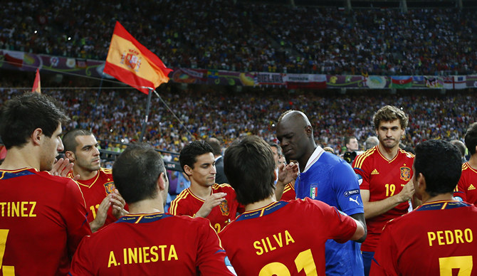 Spain players comfort Italy's Balotelli after defeating Italy to win the Euro 2012 final soccer match at the Olympic stadium in Kiev