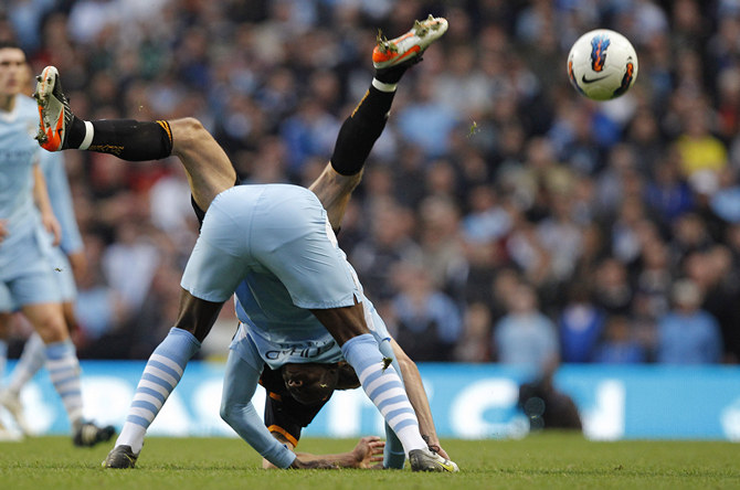 Manchester City's Balotelli challenges Wolverhampton Wanderers' Johnson during their English Premier League soccer match in Manchester