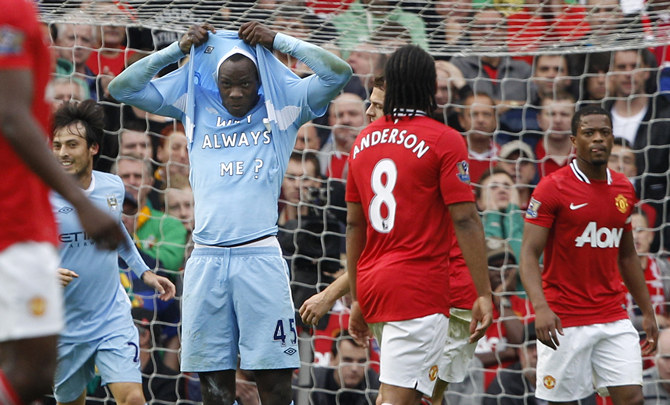 Manchester City's Mario Balotelli celebrates after scoring the opening goal against Manchester United during their English Premier League soccer match at Old Trafford in Manchester,