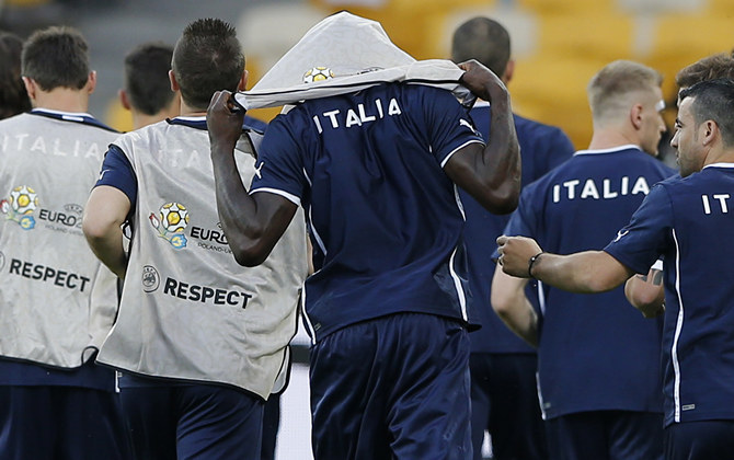 Italy's Balotelli puts on a bib during a training session at the Olympic Stadium in Kiev