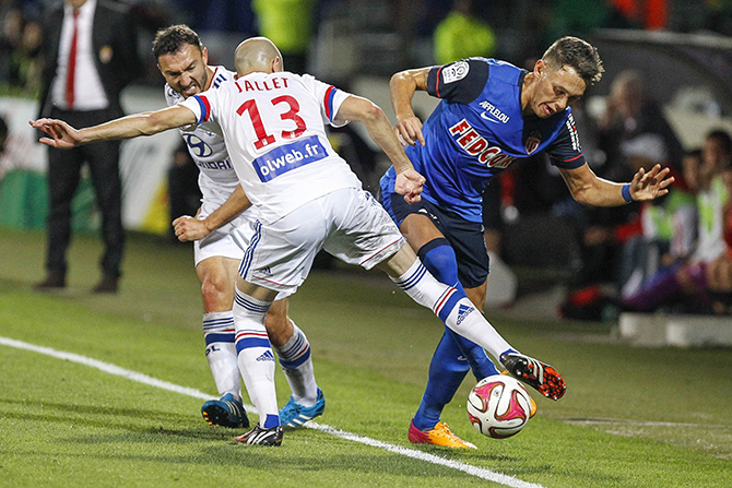 Olympique Lyon's Jallet and Malbranque challenge Ocampos of Monaco during their French Ligue 1 soccer match in Lyon
