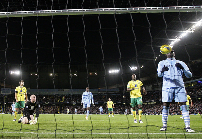 Manchester City's Balotelli scores past Norwich City's Ruddy during their English Premier League soccer match in Manchester