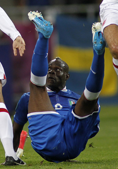 Italy's Balotelli falls over during their Euro 2012 quarter-final soccer match against England at the Olympic Stadium in Kiev