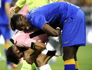 Juventus' Pogba helps Palermo's Pisano during their Italian Serie A soccer match in Turin