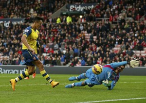 Arsenal's Alexis Sanchez shoots to score past Sunderland goalkeeper during their English Premier League soccer match at the Stadium of Light in Sunderland