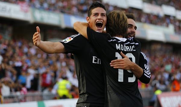 Real Madrid's Rodriguez is congratulated by teammates after scoring against Granada during their soccer match in Granada