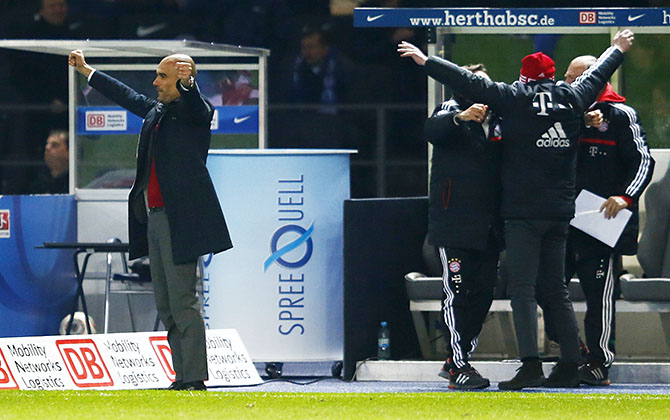 Bayern Munich's coach Guardiola sport director Sammer celebrate winning Bundesliga title after Bundesliga soccer match against Hertha Berlin in Berlin