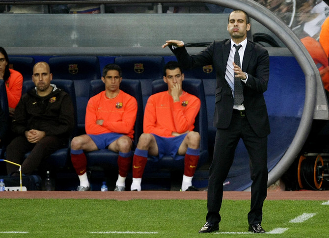 Barcelona's coach Guardiola gestures to his players during their Spanish First Division soccer match against Villarreal at Nou Camp stadium in Barcelona