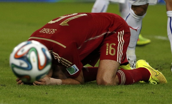 Spain's Sergio Busquets reacts after missing a chance to score a goal during their 2014 World Cup Group B soccer match against Chile at the Maracana stadium in Rio de Janeiro