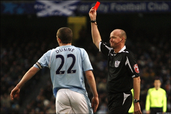 Manchester City's Richard Dunne (L) is s