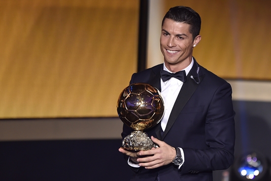 Real Madrid and Portugal forward Cristiano Ronaldo smiles after receiving the  2014 FIFA Ballon d'Or award for player of the year during the FIFA Ballon d'Or award ceremony at the Kongresshaus in Zurich on January 12, 2015.  AFP PHOTO / FABRICE COFFRINI        (Photo credit should read FABRICE COFFRINI/AFP/Getty Images)