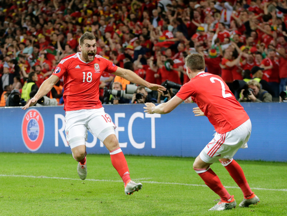 Wales' Sam Vokes, left, celebrates with his teammate Wales' Chris Gunter, after scoring his side's third goal during the Euro 2016 quarterfinal soccer match between Wales and Belgium, at the Pierre Mauroy stadium in Villeneuve d¿Ascq, near Lille, France, Friday, July 1, 2016. (AP Photo/Petr David Josek)